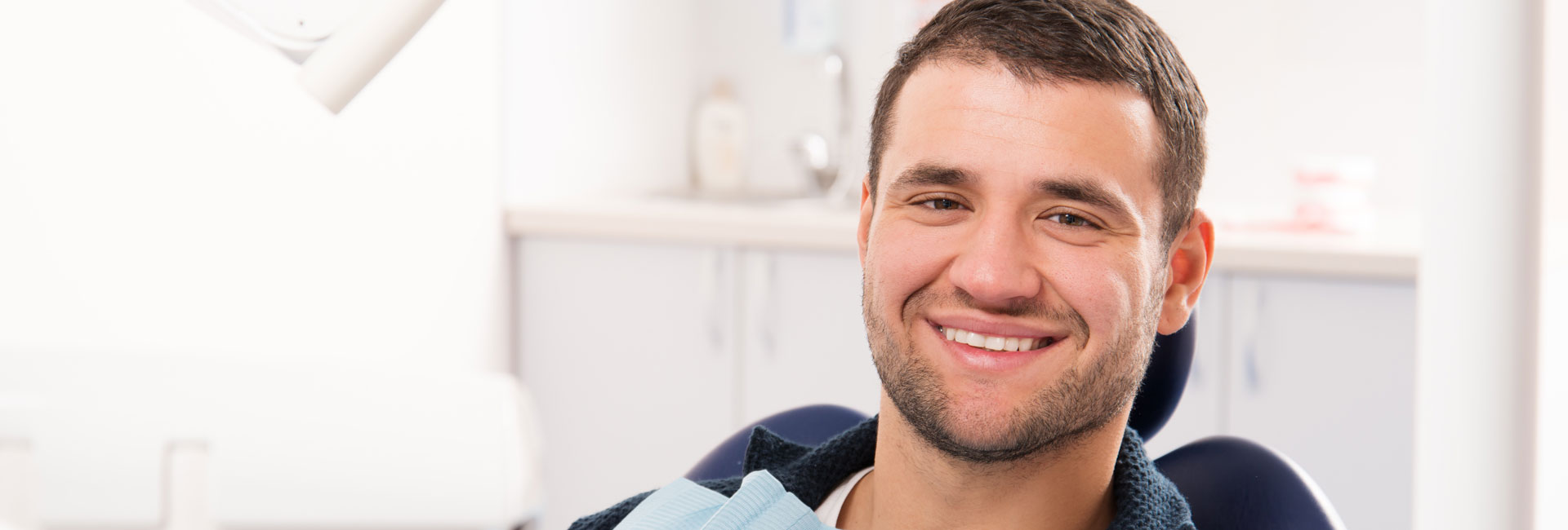 Happy man after having dental implant treatment
